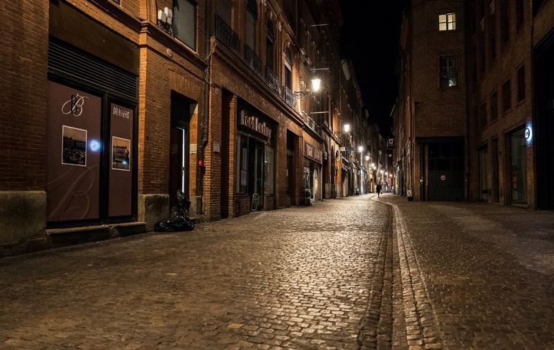 A photograph taken on October 24, 2020 shows the empty streets of Toulouse southwestern France, at during the curfew put in place to fight against the spread of the Covid-19, (the novel coronavirus). - France has registered on October 23, 2020 more than one million cases of coronavirus since the global pandemic began, with more than 42,000 new infections reported in the last 24 hours, French health services said. (Photo by Fred SCHEIBER / AFP)