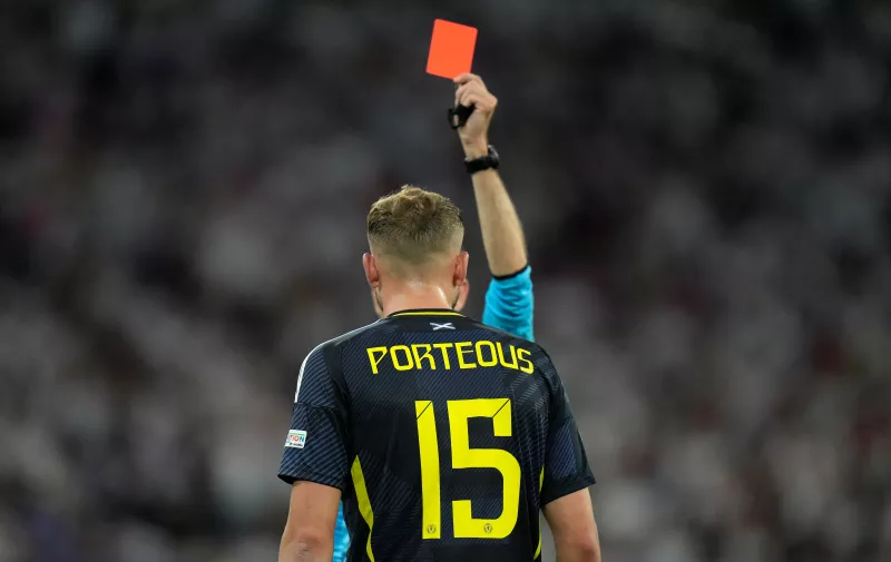 Scotland's Ryan Porteous is shown a red card by referee Clement Turpin after a challenge on Germany's Ilkay Gundogan during a Group A match between Germany and Scotland at the Euro 2024 soccer tournament in Munich, Germany, Friday, June 14, 2024. (AP Photo/Matthias Schrader)