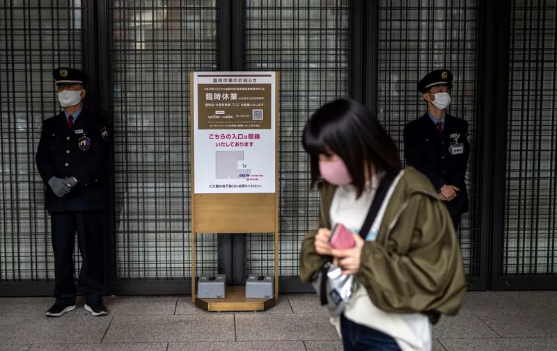 Security guards stand in front of a closed department store in Tokyo on April 27, 2021, during a coronavirus state of emergency covering Tokyo, Osaka, Kyoto and Hyogo regions. (Photo by Charly TRIBALLEAU / AFP)