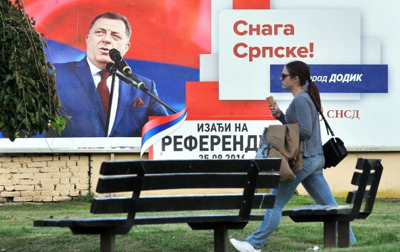 This photo taken on September 24, 2016 shows a billboard featuring the leader of the Party of Independent Social Democrats Milorad Dodik reading "Get out on Referendum Day 25.09.2016" and "The Power of Srpska", prior to a referendum vote on January 9 becoming a national holiday, in the western Bosnian town of Banja Luka. 
Citizens of Bosnia and Herzegovina's Serb-dominated entity of Republika Srpska will vote on the referendum question "Should January 9 become a national holiday?" The referendum remains scheduled for September 25, even after it was disputed by the Peace Implementation Committee in Bosnia and banned by country's Constitutional Court, ramping up tensions in the fragile country. The date is controversial as it marks the proclamation of a "Republic of Serb people" in Bosnia three months before the inter-ethnic 1992-1995 war that claimed 100,000 lives. / AFP PHOTO / ELVIS BARUKCIC