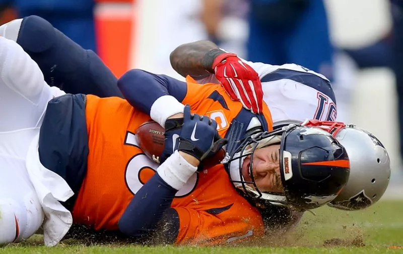 DENVER, CO - JANUARY 24: Peyton Manning #18 of the Denver Broncos is sacked by Jamie Collins #91 of the New England Patriots in the second half in the AFC Championship game at Sports Authority Field at Mile High on January 24, 2016 in Denver, Colorado.   Justin Edmonds/Getty Images/AFP