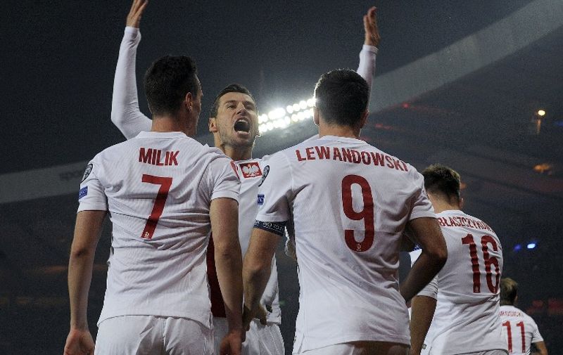 Poland's Grzegorz Krychowiak of Poland (C) celebrates after Poland's Robert Lewandowski (3rd L) scored the opening goal during the UEFA Euro 2016 qualifying Group D football match between Scotland and Poland at Hampden Park in Glasgow, Scotland, on October 8, 2015.   AFP PHOTO / ANDY BUCHANAN