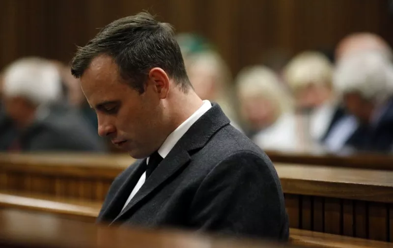 Paralympian athlete Oscar Pistorius (L), accused of the murder of his girlfriend Reeva Steenkamp three years ago, looks on during the hearing in his murder trail at the High Court in Pretoria, on July 6, 2016.
Paralympian Oscar Pistorius will learn on July 6 how long he will spend in jail when a judge sentences him for murdering his girlfriend Reeva Steenkamp three years ago. Pistorius was freed from prison in the South African capital Pretoria last October after serving one year of a five-year term for culpable homicide -- the equivalent of manslaughter.
 / AFP PHOTO / POOL / MARCO LONGARI