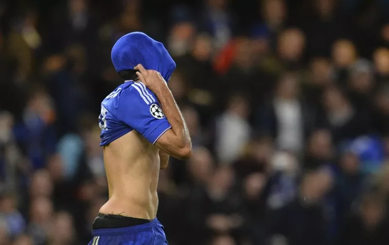 Chelsea's Brazilian-born Spanish striker Diego Costa pulls his shirt over his face as he reacts after not getting a foul after going down in the under a challenge from Porto's Portuguese midfielder Danilo when he was through on goal during the UEFA Champions League Group G football match between Chelsea and Porto at Stamford Bridge in London on December 9, 2015.   / AFP / GLYN KIRK