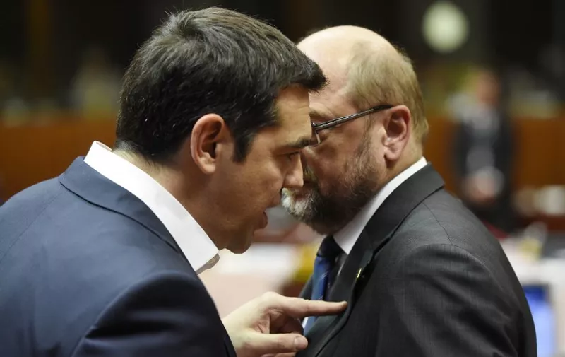 Greek prime minister Alexis Tsipras (L) speaks with European parliament president Martin Schulz before the start of a round table meeting as part on an EU summit at the EU headquarters in Brussels on June 25, 2015.    Talks between eurozone finance ministers broke up without agreeing on a Greek debt deal, with a new meeting due in coming days, Finland's Alexander Stubb said.  AFP PHOTO/ ALAIN JOCARD