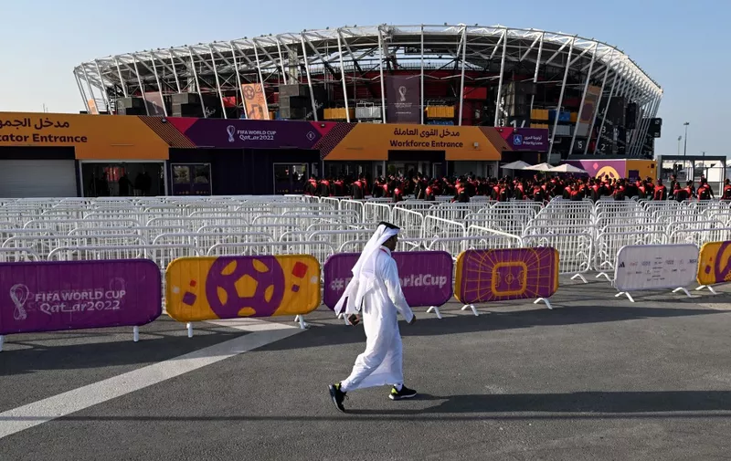 A man walks past the Stadium 974 in Doha on November 15, 2022, ahead of the Qatar 2022 World Cup football tournament. (Photo by Kirill KUDRYAVTSEV / AFP)