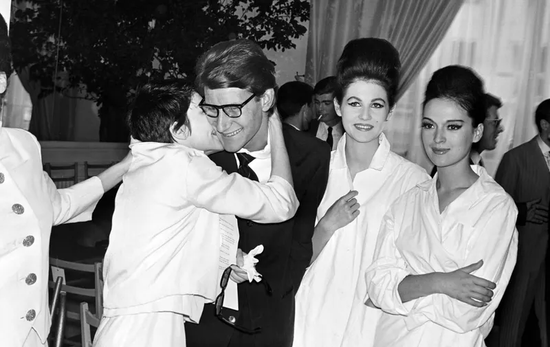 French dancer Zizi Jeanmaire (L) kisses designer Yves Saint-Laurent on July 30, 1962 after the presentation of the Haute couture fashion show in Paris. (Photo by AFP)