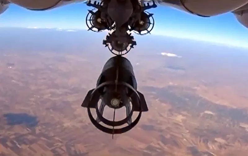 TOPSHOTS
A video grab made on October 6, 2015, shows an image taken from a footage made available on the Russian Defence Ministry's official website on October 5, purporting to show a Russia's Su-24M bomber dropping bombs during an airstrike in Syria. AFP PHOTO / RUSSIAN DEFENCE MINISTRY 
RESTRICTED TO EDITORIAL USE - MANDATORY CREDIT " AFP PHOTO / RUSSIAN DEFENCE MINISTRY" - NO MARKETING NO ADVERTISING CAMPAIGNS - DISTRIBUTED AS A SERVICE TO CLIENTS