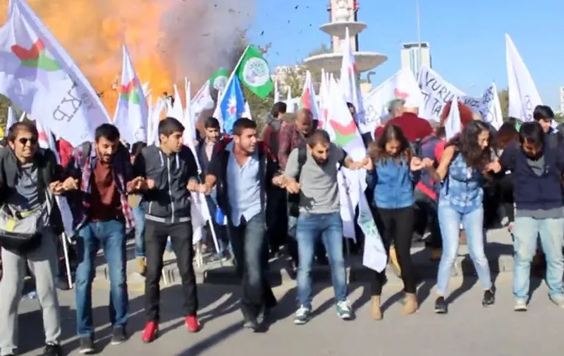 This video grab image taken from footage made avaliable by Turkish News Agency "Dokuz8" shows the moment an explosion ripped through a gathering ahead of a planned peace rally in Ankara on October 10, 2015.  At least 30 people were killed and 126 wounded in twin blasts targeting a peace rally outside the train station in the Turkish capital Ankara, the interior ministry said in a statement.
The area was to have hosted a peace rally organised by leftist groups later in the day, including the pro-Kurdish Peoples' Democratic Party (HDP).   AFP PHOTO /Dokuz8 News Agency / @dokuz8haber   - VIDEO GRAB