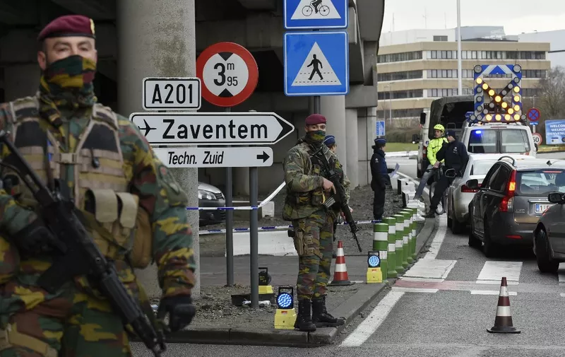 (FILES) In this file photo taken on March 29, 2016, policemen and soldiers check Brussels airport employees at its entrance, in Zaventem, following attacks on the Belgian capital. - Preliminary hearings in the trial of the March 22, 2016, jihadist attacks in Brussels open on September 12, 2022. The Brussels court of assizes begins its work with a hearing scheduled for one day to settle procedural issues, but where nine defendants are already expected, including the French jihadist Salah Abdeslam. A tenth, presumed dead in Syria, will be tried in his absence. The Brussels attacks were committed by the same jihadist cell as those of November 13, 2015 in Paris, which killed 130. They were also claimed by the Islamic State organisation. Three men blew themselves up, two at the airport and another in the metro, injuring hundreds in addition to the 32 dead. (Photo by JOHN THYS / AFP)
