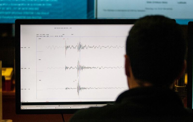 A technician of the National Seismological Center (CSN) of the University of Chile, organization in charge of monitoring the seismic activity in the Chilean territory, works in Santiago, August 4, 2017. - Chile has put the San Ramon geological fault capable of destroying the eastern zone of Santiago- under vigilance to try to figure out how this potentially elevated seismic source behaves. (Photo by CHRISTIAN MIRANDA / AFP) / TO GO WITH AFP STORY BY GIOVANNA FLEITAS