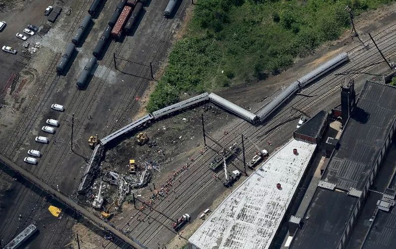 PHILADELPHIA, PA - MAY 13: Investigators and first responders work near the wreckage of Amtrak Northeast Regional Train 188, from Washington to New York, that derailed yesterday May 13, 2015 in north Philadelphia, Pennsylvania. At least six people were killed and more than 200 others were injured in the crash.   Win McNamee/Getty Images/AFP