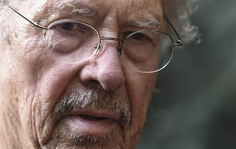 Austrian writer Peter Handke poses in Chaville, in the Paris surburbs, on October 10, 2019 after he was awarded with the 2019 Nobel Literature Prize. - Austrian Peter Handke, one of the most original German-language writers alive, who once used his famously sharp tongue to call for the Nobel Prize in Literature to be abolished, was awarded with the 2019 Nobel Literature Prize on October 10. The prize brings its winner "false canonisation" along with "one moment of attention (and) six pages in the newspaper," the novelist, playwright, poet and translator told Austrian media in 2014. (Photo by ALAIN JOCARD / AFP)