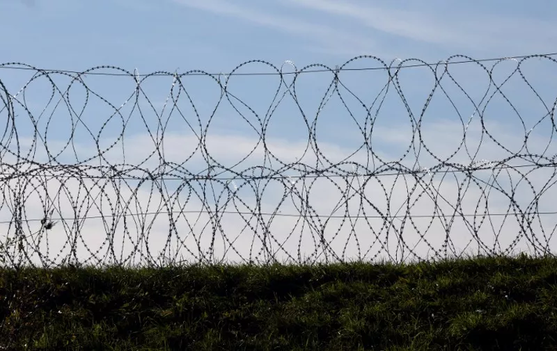 A barbed wire fence has been set along the Slovenian-Croatian border in Sela pri Dobovi near Brezice, on November 11, 2015. Slovenia on November 10, 2015 outlined plans to build "obstacles", potentially including fences, on its border with fellow EU member Croatia, as it braced for a new spike in migrants bound for northern Europe this week. Prime Minister Miro Cerar, whose country last month found itself on the main Balkans route for thousands of migrants after Hungary sealed its southern borders, insisted however that its frontier would remain open. AFP PHOTO/STRINGER / AFP / STR