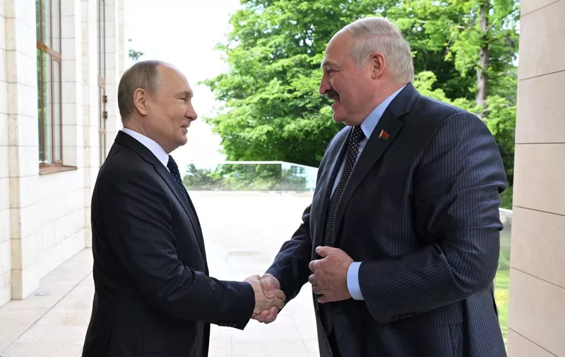 Russian President Vladimir Putin meets with his Belarus' counterpart Alexander Lukashenko in the Black Sea resort of Sochi on May 23, 2022. (Photo by Ramil Sitdikov / SPUTNIK / AFP)