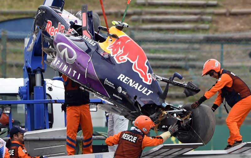 The race car of Red Bull driver Daniil Kvyat of Russia is moved onto a truck after his crash in the qualifying session at the Formula One Japanese Grand Prix in Suzuka on September 26, 2015. AFP PHOTO / TOSHIFUMI KITAMURA