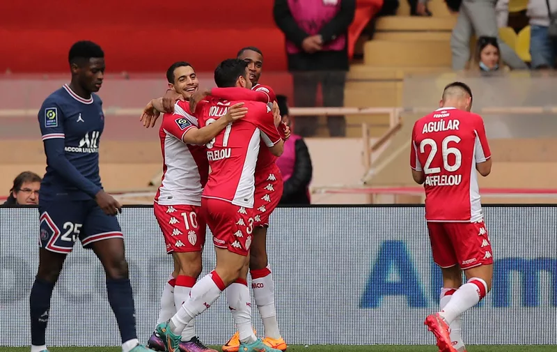 Monaco's Kevin Volland celebrates with teammates after scoring his side's second goal during the French League One soccer match between Monaco and Paris Saint-Germain at the Stade Louis II in Monaco, Sunday, March 20, 2022. (AP Photo/Daniel Cole)