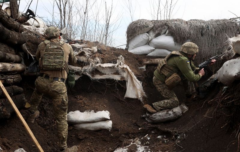 Ukrainian soldiers keep their position in a trench on the front line with Russian troops in Lugansk region on April 11, 2022. (Photo by Anatolii STEPANOV / AFP)