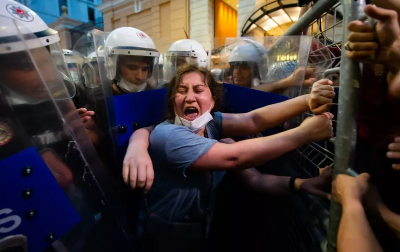 Women demonstrators clash with Turkish police as they protest against Turkey's decision to withdraw from the Istanbul Convention, in Istanbul,on July 1, 2021. - Police fired tear gas at protesters in Istanbul demonstrating against Turkey's controversial exit on July 1, 2021 from a treaty combatting femicide and domestic abuse. Turkish President Recep Tayyip Erdogan sparked international outrage in March by pulling out of the world's first binding treaty to prevent and combat violence against women, known as the Istanbul Convention. (Photo by YASIN AKGUL / AFP)