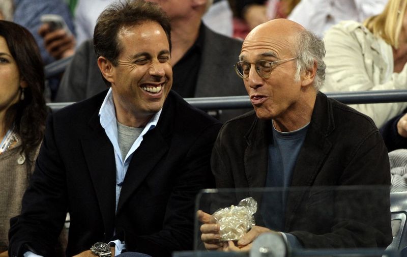TO GO WITH STORY by Rob Woollard, Entertainment-US-film-Seinfeld
(FILES) In this 05 September 2007 file photo, US actors Jerry Seinfeld (C) and Larry David (R) watch a tennis match at the 2007 US Open, in Flushing Meadows, New York. The comedian, who became a billionaire thanks to a long-running television comedy that chronicled the chaotic lives of four people living in New York's concrete jungle, has returned in the animated film "Bee Movie," which is about discontented honey bee Barry Benson, who yearns for a better life away from the hive.  AFP PHOTO/Emmanuel DUNAND/FILES (Photo by EMMANUEL DUNAND / AFP)