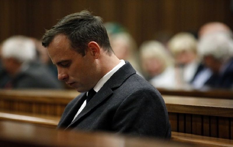 Paralympian athlete Oscar Pistorius (L), accused of the murder of his girlfriend Reeva Steenkamp three years ago, looks on during the hearing in his murder trail at the High Court in Pretoria, on July 6, 2016.
Paralympian Oscar Pistorius will learn on July 6 how long he will spend in jail when a judge sentences him for murdering his girlfriend Reeva Steenkamp three years ago. Pistorius was freed from prison in the South African capital Pretoria last October after serving one year of a five-year term for culpable homicide -- the equivalent of manslaughter.
 / AFP PHOTO / POOL / MARCO LONGARI