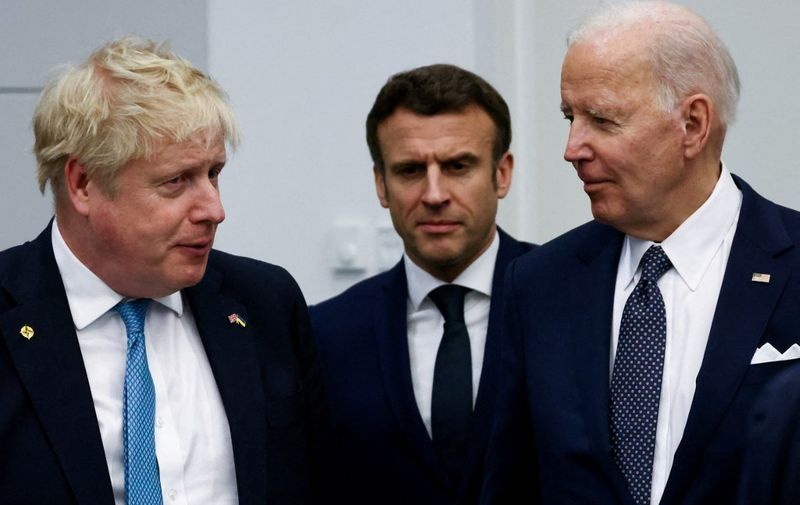 (L/R): Britain's Prime Minister Boris Johnson, U.S. President Joe Biden and France's President Emmanuel Macron arrive for a G7 leaders meeting during a NATO summit at the alliance's headquarters in Brussels on March 24, 2022. (Photo by HENRY NICHOLLS / POOL / AFP)