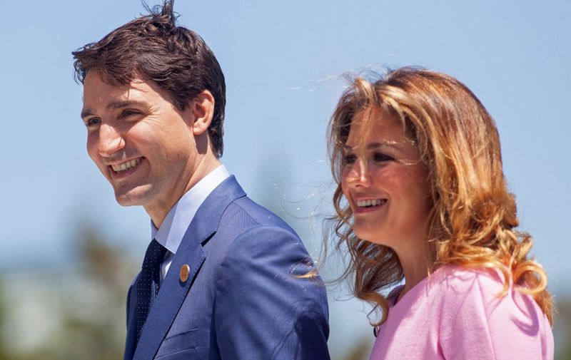 (FILES) In this file photo taken on June 08, 2018 Prime Minister of Canada Justin Trudeau and his wife Sophie Gregoire Trudeau arrive for a welcome ceremony for G7 leaders on the first day of the summit in La Malbaie, Quebec, Canada. - Canadian Prime Minister Justin Trudeaus wife said March 28, 2020 that she has recovered from being ill from COVID-19 disease caused by the new coronavirus. "I am feeling so much better," Sophie Gregoire Trudeau said in a statement on social media. She said she received the clearance from her doctor and Ottawa Public Health. (Photo by GEOFF ROBINS / AFP)