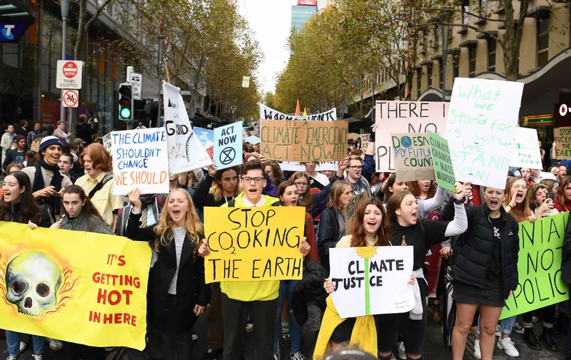 MELBOURNE, AUSTRALIA - MAY 24: Protestors march down city streets on their way to stage a 'Die In' in at the corner of Bourke and Swanston Streets on May 24, 2019 in Melbourne, Australia. Protestors including the 'Extinction Rebellion' took to the CBD in order to show the Earth's sixth mass extinction in reaction to Climate Change. (Photo by Quinn Rooney/Getty Images)