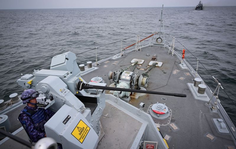 Romanian Navy personnel operates a precision heavy machine gun of the mine hunter "Second lieutenant Ion Ghiculescu" on the Black Sea during "Sea Shield 24" exercise April 16, 2024. The Romanian Navy coordinates the multinational exercise "Sea Shield 24", in which allied and partner states will take part, including Bulgaria, France, Georgia, Greece, Italy, Great Britain, Moldova, Poland, Portugal, Turkey and the United States of America. (Photo by Daniel MIHAILESCU / AFP)