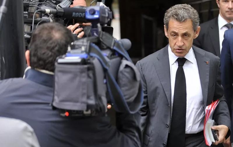 Former French President and President of French right-wing opposition party Les Republicains Nicolas Sarkozy (R) arrives for a meeting of European Popular Parties (EPP), on July 12, 2015, in Brussels, on the sidelines of an EU summit on the Greek crisis. AFP PHOTO / JEAN-CHRISTOPHE VERHAEGEN