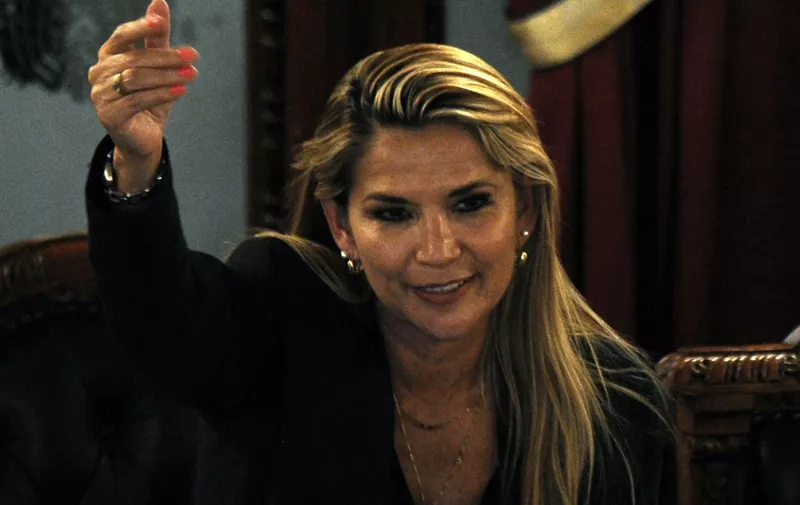 Bolivian senator Jeanine Anez, gestures after proclaiming herself the country's new interim president during a session of Congress, despite it failed to reach a quorum, on November 12, 2019 in La Paz. - Lawmakers had been summoned to formalize Sunday's resignation of Evo Morales and confirm 52-year-old Anez as interim president. Anez, second vice-president of the Senate, is constitutionally next-in-line for the presidency after the vice-president and leaders of both houses of Congress resigned along with Morales. (Photo by JORGE BERNAL / AFP)