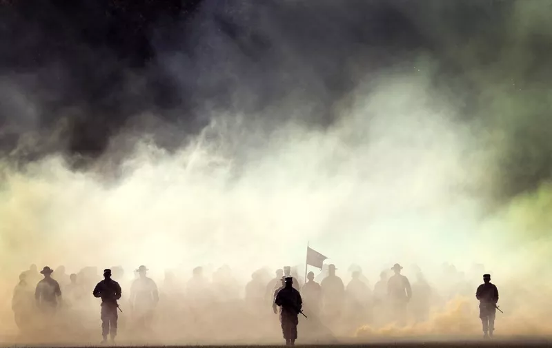 COLUMBIA, SOUTH CAROLINA - SEPTEMBER 28: U.S. Army soldiers walk from the woods, through a cloud of smoke, for the start of a Family Day ceremony while attending basic training at Fort Jackson on September 28, 2022 in Columbia, South Carolina. Family Day marks the first time Army recruits can see their families since arriving for basic training. Following the ceremony the soldiers are given a day pass to spend time with their families but are required to report back to their barracks later in the evening. Fort Jackson, the largest of the Army's four basic training facilities, trains 60 percent of the Army's new recruits. This past year, the Army has struggled to meet its recruiting goals, falling short by about 15,000 recruits or about 25 percent of its goal as it closed the fiscal year.   Scott Olson/Getty Images/AFP (Photo by SCOTT OLSON / GETTY IMAGES NORTH AMERICA / Getty Images via AFP)