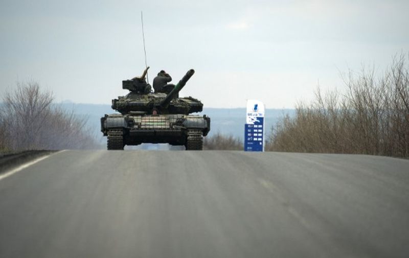 Pro-Russian separatist soldiers stand on their tank as they drive along a road near the village of Kirovske on April 21, 2015 in the self-proclaimed Donetsk People&#8217;s Republic (DNR). A Ukrainian soldier was killed on the frontline in fighting with pro-Russian separatists in the east, the army said on April 21, its first fatality in [&hellip;]