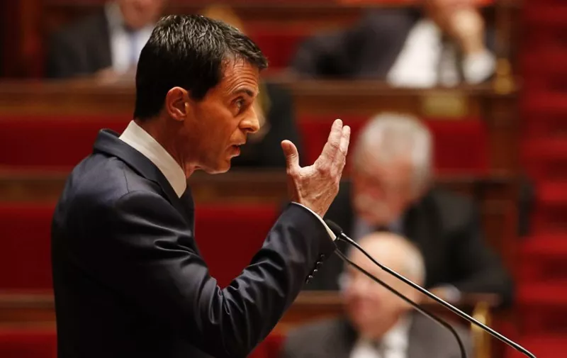 French Prime Minister Manuel Valls gestures as he addresses French lawmakers debating a measure that would extend a state of emergency declared by the French president until the end of February, at the National Assembly in Paris on November 19, 2015. Prime Minister Manuel Valls warned of the danger of an attack in France using "chemical or biological weapons", in a speech to lawmakers debating the extension of a state of emergency. AFP PHOTO / FRANCOIS GUILLOT / AFP / FRANCOIS GUILLOT