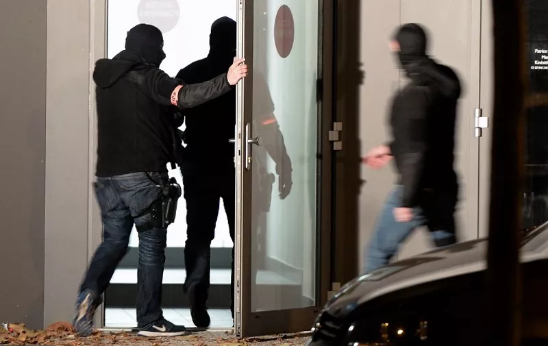 Policemen enter a building , on November 16, 2015 in Strasbourg, eastern France, during investigations following the attacks in Paris, claimed by Islamic State which killed at least 129 people and left more than 350 injured on November 13. French police carried out nearly 170 searches and arrested 23 people in raids overnight Sunday in the wake of the attacks on Paris and more than 100 people have been placed under house arrest, the interior minister said.  AFP PHOTO / FREDERICK FLORIN / AFP / FREDERICK FLORIN
