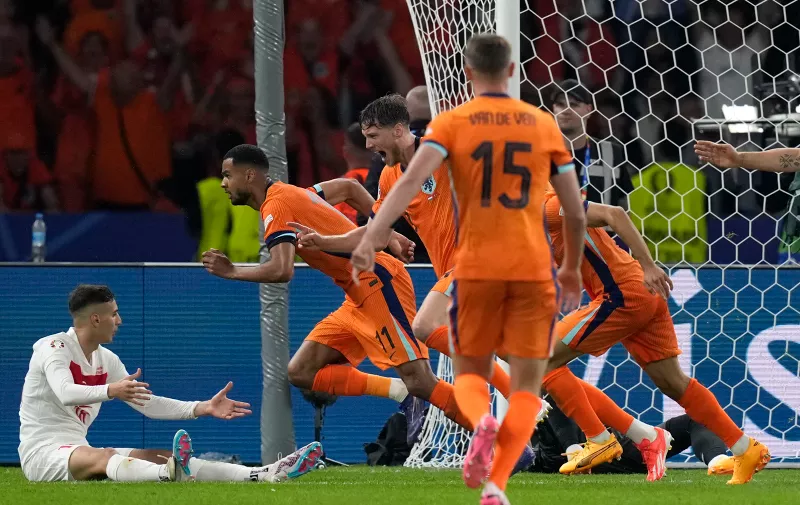 Cody Gakpo of the Netherlands, 2nd left, celebrates with his teammates after his sides second goal during a quarterfinal match between the Netherlands and Turkey at the Euro 2024 soccer tournament in Berlin, Germany, Saturday, July 6, 2024. (AP Photo/Ariel Schalit)