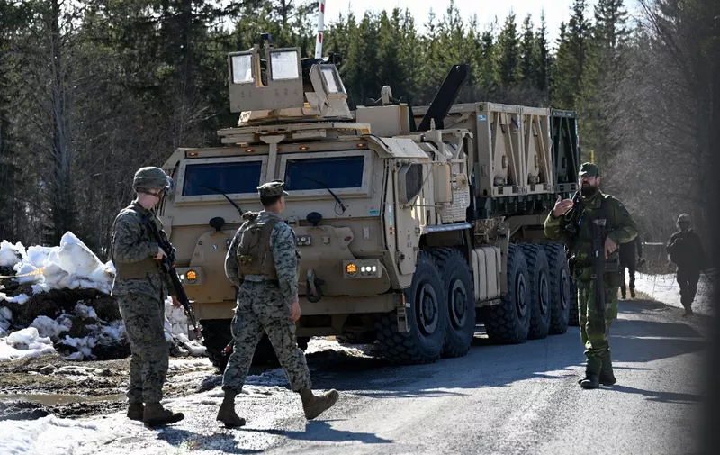 Members of the US Marine Corps (L) and Swedish troops are seen during the start of the defence exercise Aurora 23 near Ostersund on April 17, 2023 . Gathering 26,000 soldiers from 14 nations, Sweden on April 17, 2023 launched its largest military manoeuvres in more than 25 years, as the country's bid to join NATO remains blocked.
"The exercise takes place in the air, on the ground and at sea in large parts of the country," the Swedish Armed Forces said, announcing the exercise which is scheduled to run until May 11. (Photo by Pontus LUNDAHL / various sources / AFP) / Sweden OUT