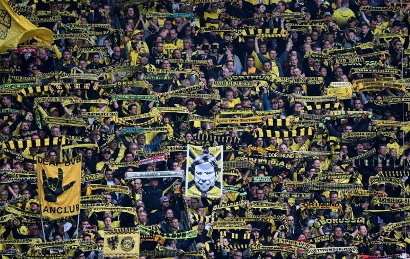 Dortmund supporters hold a placard showing Dortmund's head coach Juergen Klopp prior to the German first division Bundesliga football match between Borussia Dortmund and Eintracht Frankfurt at the Signal Iduna Park stadium in Dortmund, western Germany, on April 25, 2015. AFP PHOTO / PATRIK STOLLARZ

RESTRICTIONS - DFL RULES TO LIMIT THE ONLINE USAGE DURING MATCH TIME TO 15 PICTURES PER MATCH. IMAGE SEQUENCES TO SIMULATE VIDEO IS NOT ALLOWED AT ANY TIME. FOR FURTHER QUERIES PLEASE CONTACT DFL DIRECTLY AT + 49 69 650050.