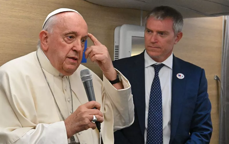 Pope Francis addresses journalists aboard the Papal plane heading to Mongolia on August 31, 2023. (Photo by Alberto PIZZOLI / POOL / AFP)