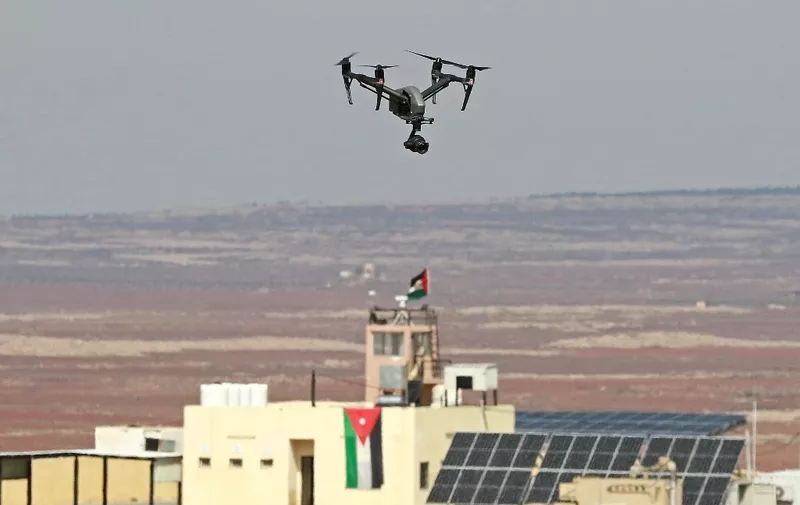 A picture taken during a tour origanized by the Jordanian Army shows a drone flying over an observation post along the border with Syria, on February 17, 2022. Drug trafficking from Syria into Jordan is becoming "organised" with smugglers stepping up operations and using sophisticated equipment including drones, Jordan's army said, warning of a shoot-to-kill policy. Since the beginning of this year, Jordan's army has killed 30 smugglers and foiled attempts to smuggle into the kingdom from Syria 16 million Captagon pills -- more than they seized in the whole of 2021 -- the military said. (Photo by Khalil MAZRAAWI / AFP)