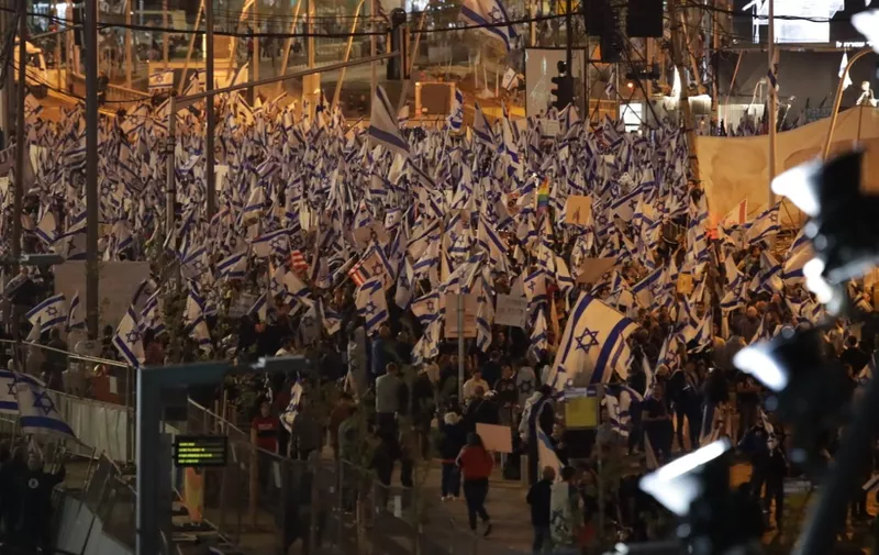 TEL AVIV, ISRAEL - APRIL 1: Demonstrators march with Israeli flags during a rally against the government's judicial reform bill in Tel Aviv, Israel on April 1, 2023. Saeed Qaq / Anadolu Agency (Photo by Saeed Qaq / ANADOLU AGENCY / Anadolu Agency via AFP)