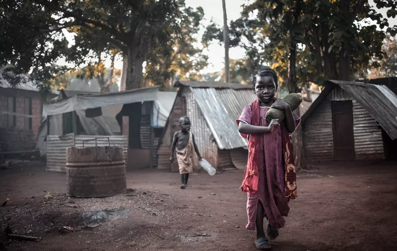 Two children play at the site of the "Petit Seminaire" in Bangassou on May 17, 2019. - In Bangassou, Muslim displaced persons from the IDP site known as the "Petit Seminaire" returned to their predominantly Muslim district of Tokoyo after two years of isolation thanks to the return of stability in the city. (Photo by FLORENT VERGNES / AFP)