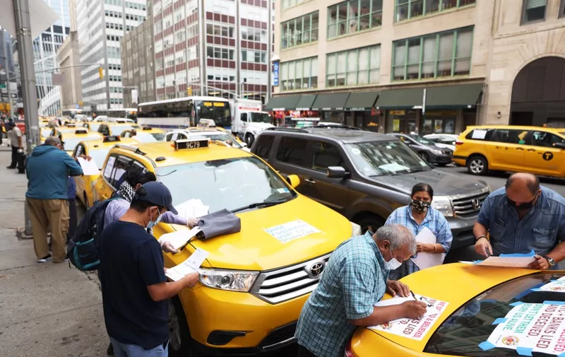 NEW YORK, NEW YORK - SEPTEMBER 17: Taxi cab drivers make last minute arrangements as they prepare to drive up to City Hall on September 17, 2020 in New York City. New York City taxi cab drivers held a day of action calling for debt forgiveness for loss of income amid work shortage due to the coronavirus (COVID-19) pandemic.   Michael M. Santiago/Getty Images/AFP (Photo by Michael M. Santiago / GETTY IMAGES NORTH AMERICA / Getty Images via AFP)