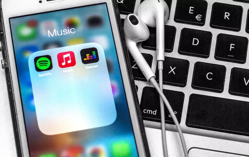 April 12, 2021, Spain: In this photo illustration a Spotify app, Apple Music app and Deezer app are seen displayed on a smartphone with headphones on a laptop keyboard.,Image: 605003859, License: Rights-managed, Restrictions: , Model Release: no, Credit line: Profimedia