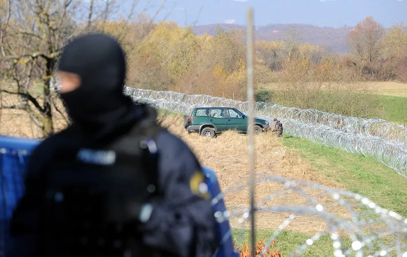 A Slovenian special police force stands after been deployed in the disputed area near the Harmica-Rigonce crossing, on November 12,2015. Slovenia found itself on the Balkans route taken by thousands of migrants heading to northern Europe after Hungary sealed its borders with Croatia and Serbia and began erecting razor wire along the border with fellow European Union member Croatia on November 11, in a move the government says will help it better manage a record influx of migrants. Croatia's foreign ministry lodged a "strong protest" with Slovenia's embassy in Zagreb for laying the wire on what it said was Croatian territory near the Harmica-Rigonce border crossing and urged Ljubljana to "remove it as soon as possible.". AFP PHOTO/STRINGER (Photo by STR / AFP)