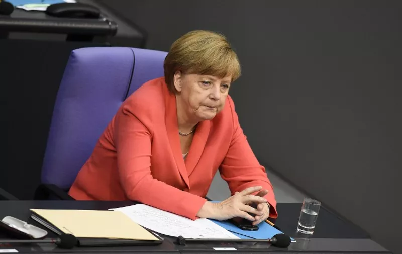 German Chancellor Angela Merkel attends a special session at the Bundestag (lower house of parliament) in Berlin on July 17, 2015. German lawmakers rally to vote on a new Greece bail-out deal, two days after the parliament in Athens grudgingly agreed to harsh reforms. AFP PHOTO / TOBIAS SCHWARZ
