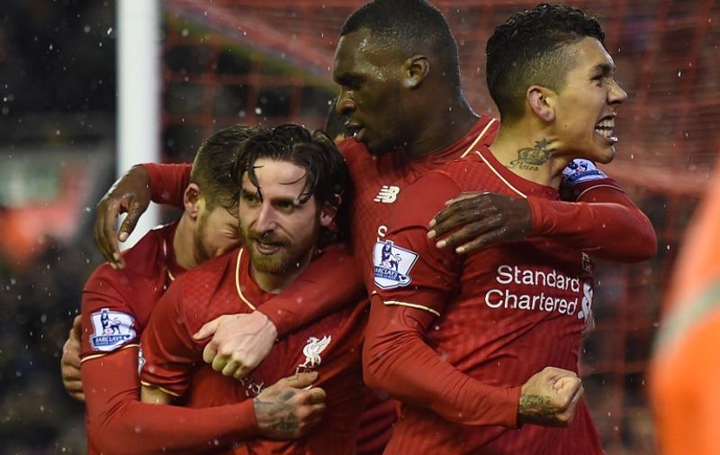 Liverpool's Welsh midfielder Joe Allen (2L) celebrates with teammates after scoring during the English Premier League football match between Liverpool and Arsenal at Anfield stadium in Liverpool, north-west England on January 13, 2016.
AFP PHOTO / PAUL ELLIS
RESTRICTED TO EDITORIAL USE. NO USE WITH UNAUTHORIZED AUDIO, VIDEO, DATA, FIXTURE LISTS, CLUB/LEAGUE LOGOS OR 'LIVE' SERVICES. ONLINE IN-MATCH USE LIMITED TO 75 IMAGES, NO VIDEO EMULATION. NO USE IN BETTING, GAMES OR SINGLE CLUB/LEAGUE/PLAYER PUBLICATIONS. / AFP / PAUL ELLIS