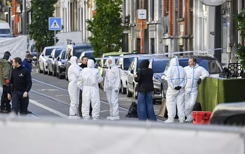 Belgian police officers from the forensic service gather in the street in the Schaerbeek area of Brussels on October 17, 2023, where the suspected perpetrator of the attack in Brussels was shot dead during a police intervention. Brussels police on October 17, 2023 shot and fatally wounded an attacker accused of gunning down two Swedish football fans in what Belgium's prime minister condemned as an act of "terrorist madness". (Photo by JOHN THYS / AFP)