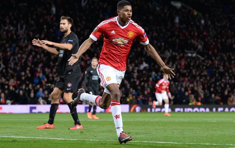 Manchester United's English striker Marcus Rashford celebrates scoring his team's second goal during the UEFA Europa League round of 32, second leg football match between Manchester United and and FC Midtjylland at Old Trafford in Manchester, north west England, on February 25, 2016. 
 / AFP / OLI SCARFF