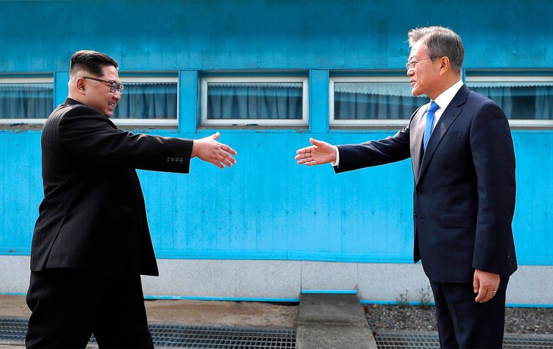 April 27, 2018 - Panmunjom, KOREA - North Korean leader Kim Jong Un, left, prepares to shake hands with South Korean President Moon Jae-in over the military demarcation line at the border village of Panmunjom in Demilitarized Zone Friday, April 27, 2018. Their discussions will be expected to focus on whether the North can be persuaded to give up its nuclear bombs., Image: 369877827, License: Rights-managed, Restrictions: , Model Release: no, Credit line: Profimedia, Zuma Press - News